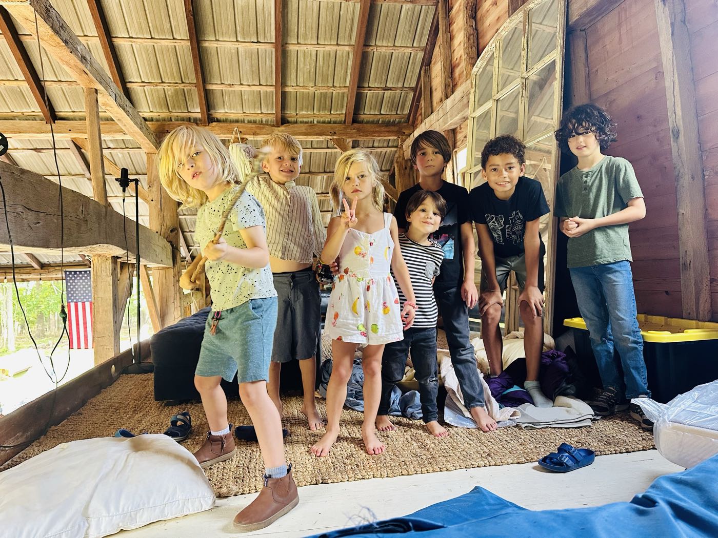Seven children lined up in the hayloft of the barn
